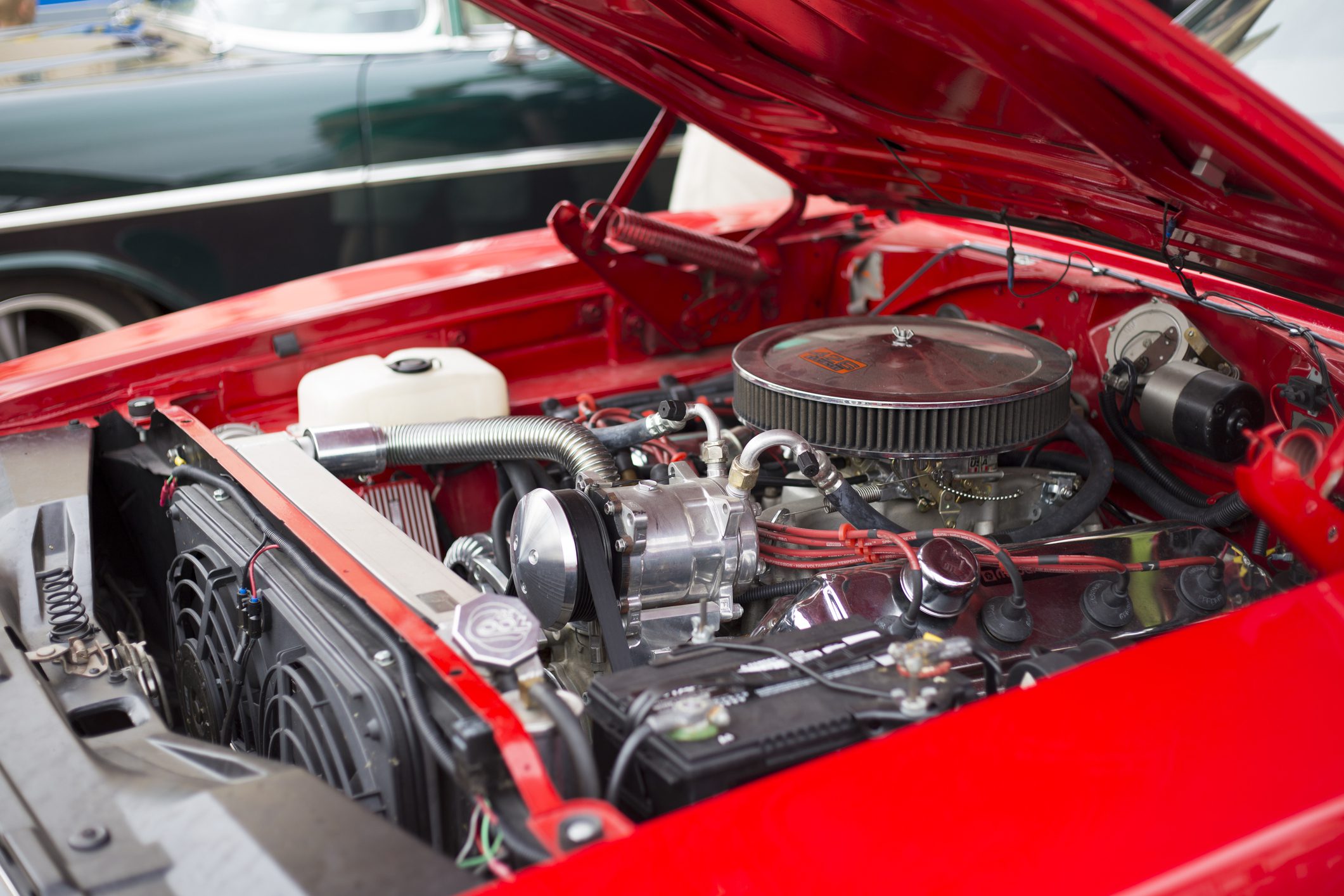 Classic car engine at a car show.